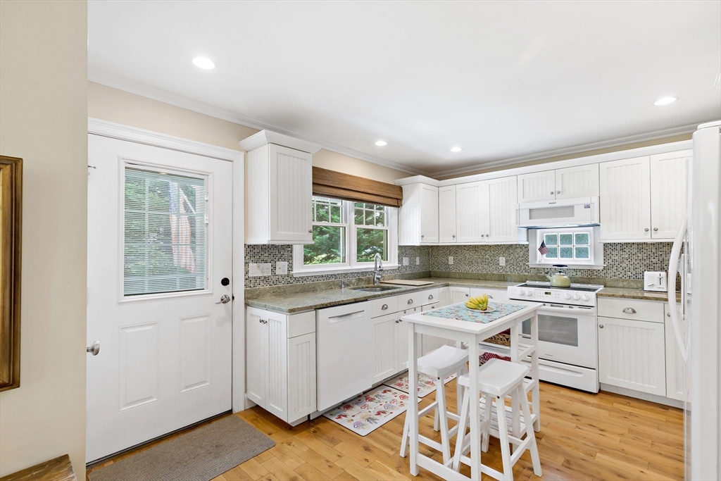 50 Pheasant Way Barnstable, MA 02632 - Photo 11 of 37 a kitchen with a sink stove and cabinets