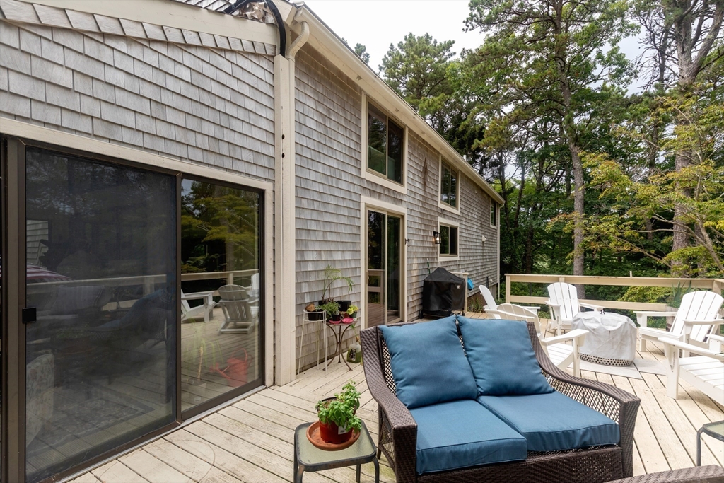 50 Pheasant Way Barnstable, MA 02632 - Photo 23 of 37 a view of a patio with couches table and chairs and potted plants