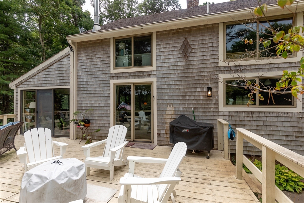 50 Pheasant Way Barnstable, MA 02632 - Photo 26 of 37 a view of a patio with table and chairs with wooden floor and fence