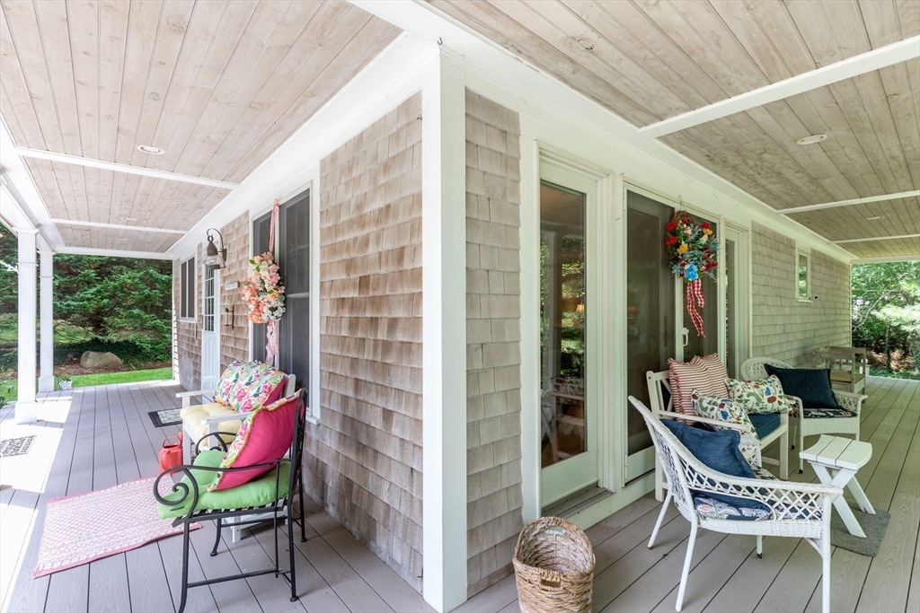 50 Pheasant Way Barnstable, MA 02632 - Photo 5 of 37 a view of a patio with table and chairs and potted plants