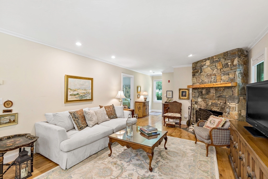 50 Pheasant Way Barnstable, MA 02632 - Photo 9 of 37 a living room with furniture a flat screen tv and a fireplace
