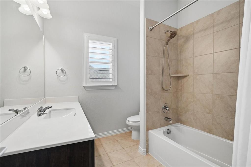 2721 Rotherham Street Prosper, TX 75078 - Photo 25 of 37 a bathroom with a sink mirror toilet and bathtub