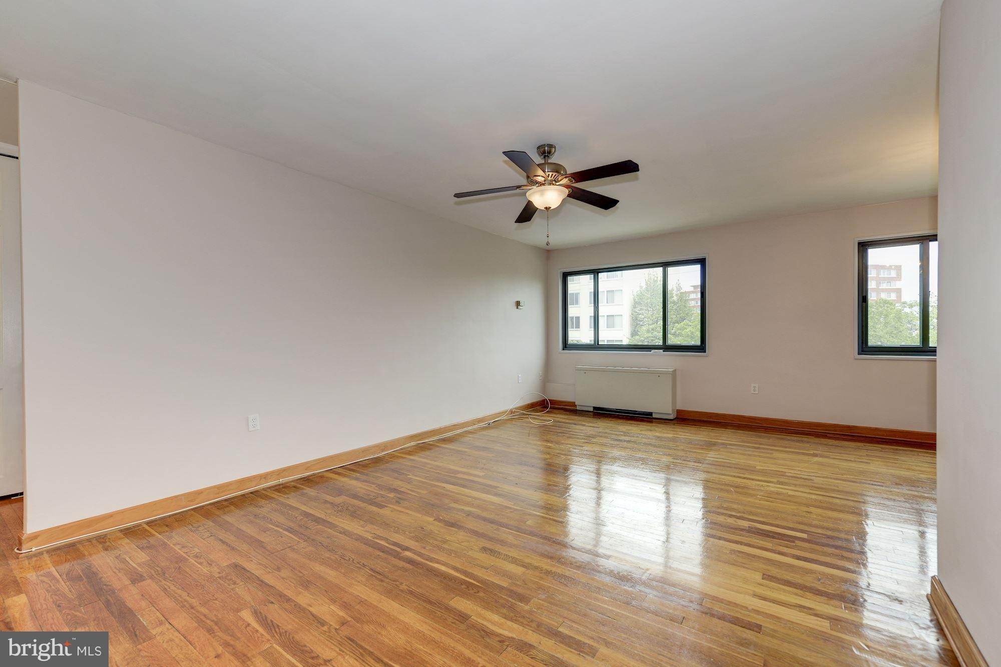 1300 South Arlington Ridge Road, Unit 508 Arlington, VA 22202 - Photo 1 of 24 a view of an empty room with window and wooden floor