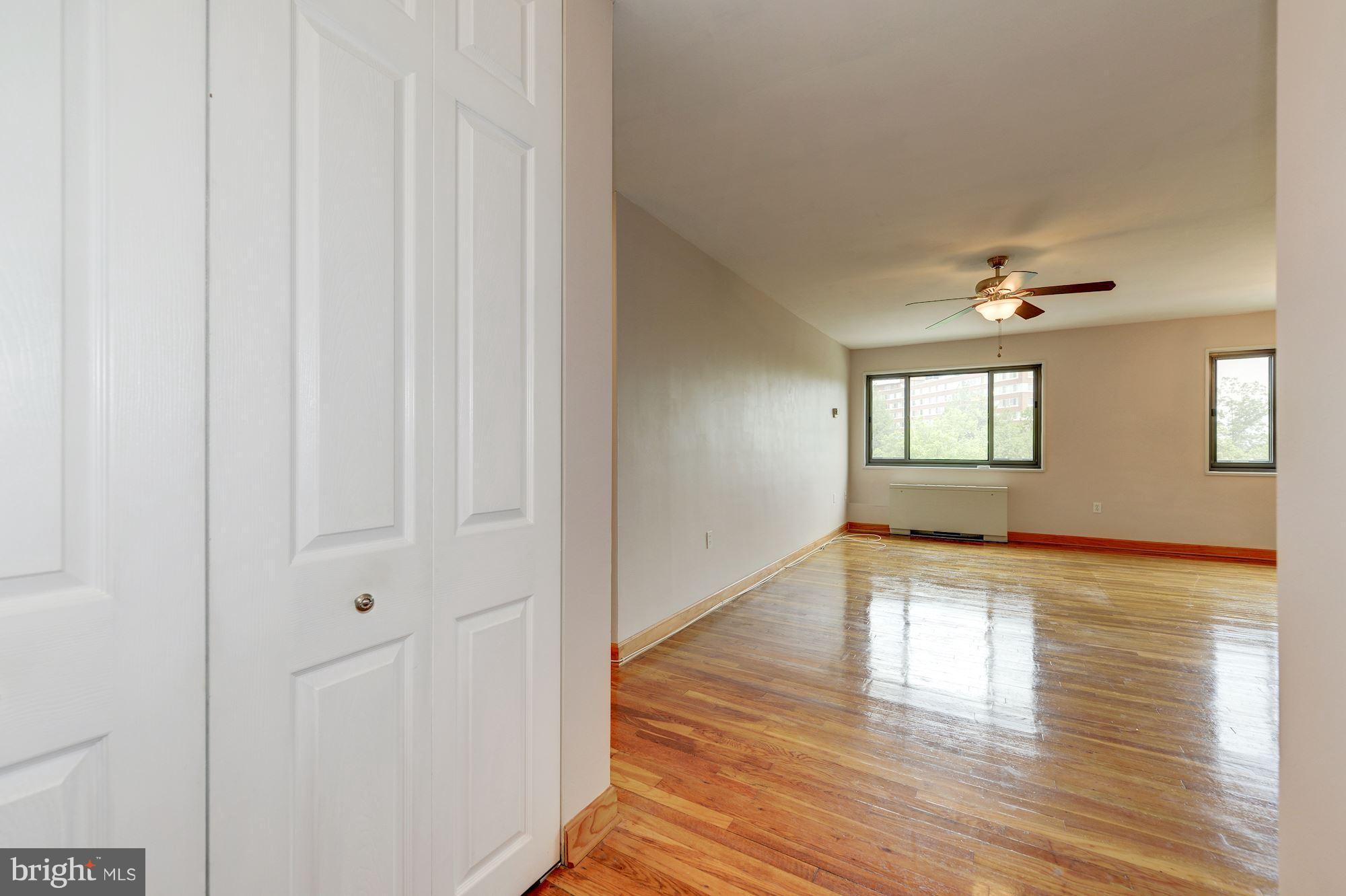 1300 South Arlington Ridge Road, Unit 508 Arlington, VA 22202 - Photo 2 of 24 a view of an empty room with wooden floor and a window