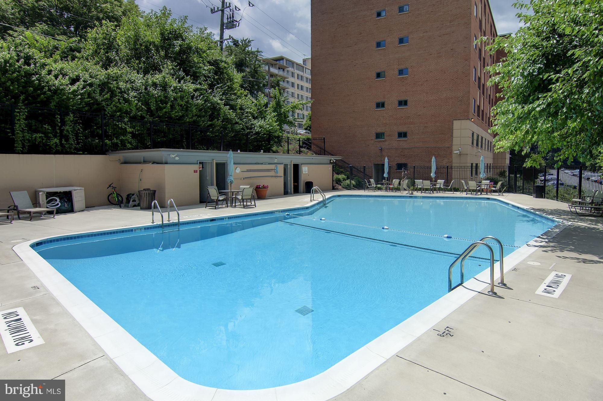 1300 South Arlington Ridge Road, Unit 508 Arlington, VA 22202 - Photo 20 of 24 a view of a swimming pool with a chair and tables