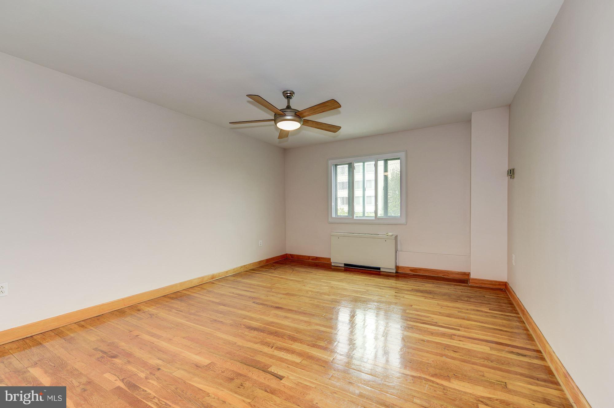 1300 South Arlington Ridge Road, Unit 508 Arlington, VA 22202 - Photo 3 of 24 a view of an empty room with wooden floor and a window