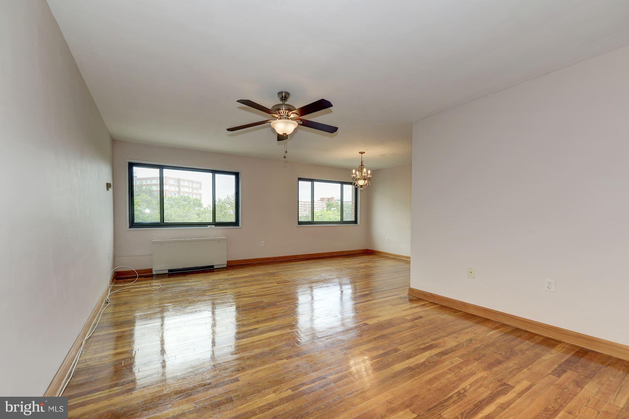 1300 South Arlington Ridge Road, Unit 508 Arlington, VA 22202 - Photo 5 of 24 an empty room with wooden floor and windows