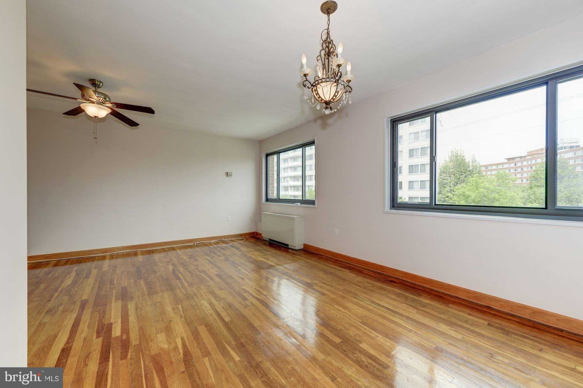 1300 South Arlington Ridge Road, Unit 508 Arlington, VA 22202 - Photo 8 of 24 a view of empty room with wooden floor and fan