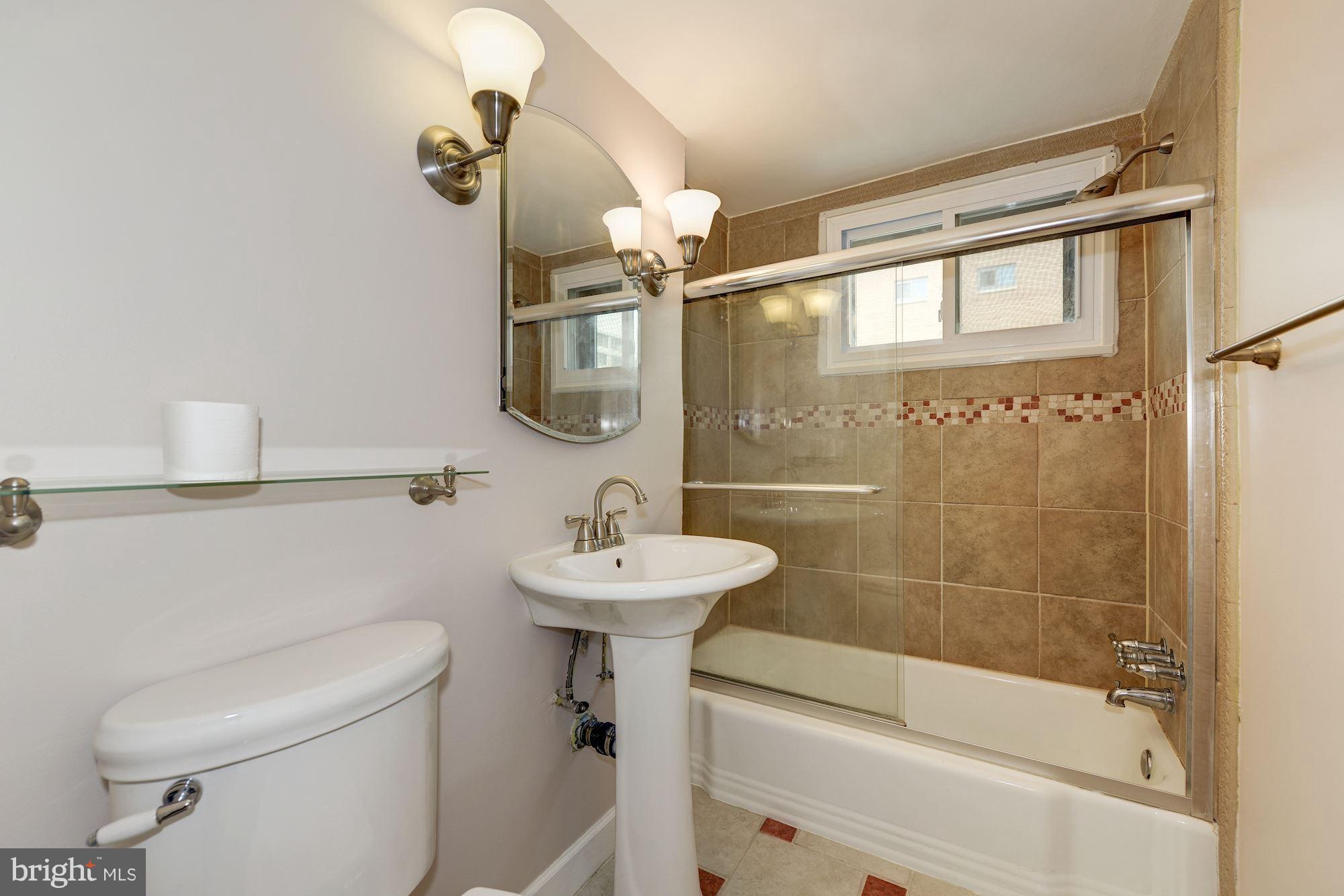 1300 South Arlington Ridge Road, Unit 508 Arlington, VA 22202 - Photo 9 of 24 a bathroom with a sink a toilet and shower