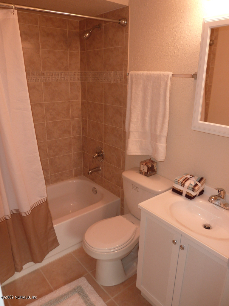 1638 Morgana Road Jacksonville, FL 32211 - Photo 6 of 8 a bathroom with a sink a toilet and bathtub