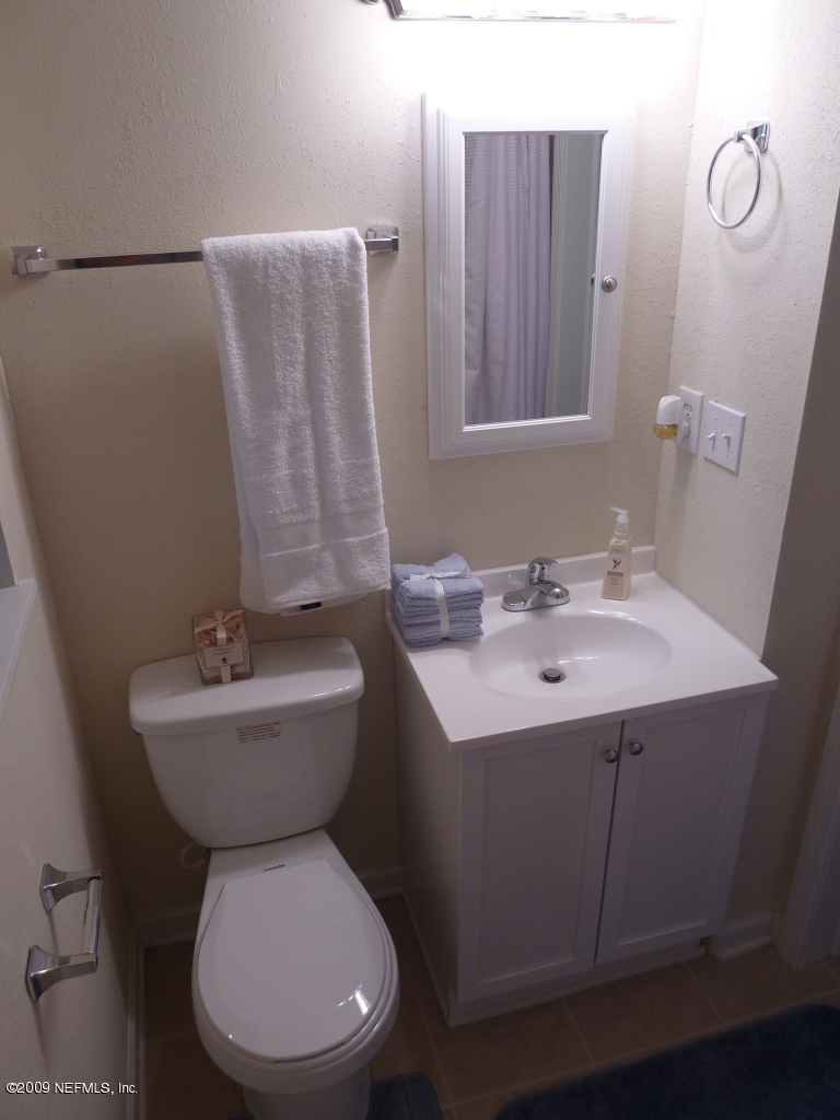 1638 Morgana Road Jacksonville, FL 32211 - Photo 7 of 8 a bathroom with a toilet sink and mirror