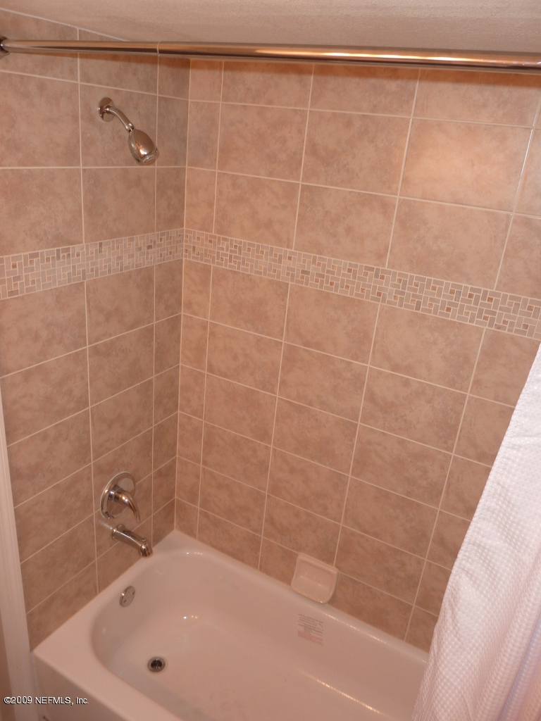 1638 Morgana Road Jacksonville, FL 32211 - Photo 8 of 8 a bathroom with a shower and a bathtub