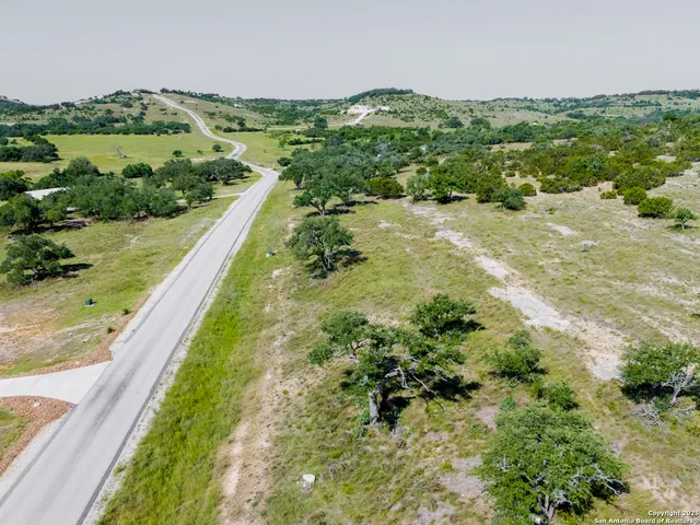a view of a green yard with a lake