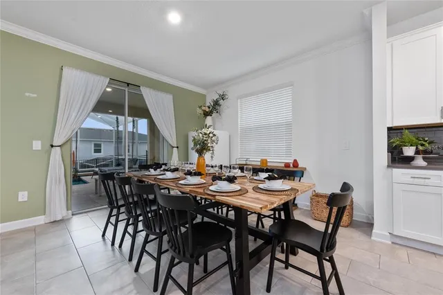 a view of a dining room and livingroom with furniture wooden floor and a rug
