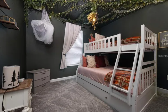 a bedroom with furniture and a window