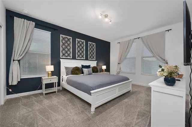 a bedroom with a bed and a potted plant