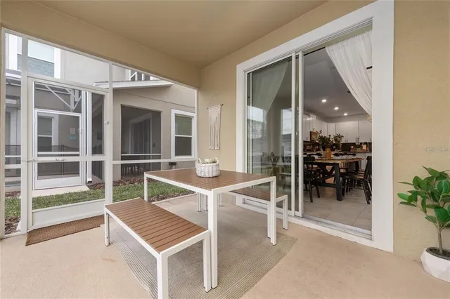 a view of a living room with furniture and floor to ceiling window