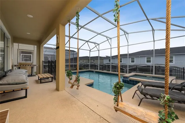 a living room with furniture and floor to ceiling window