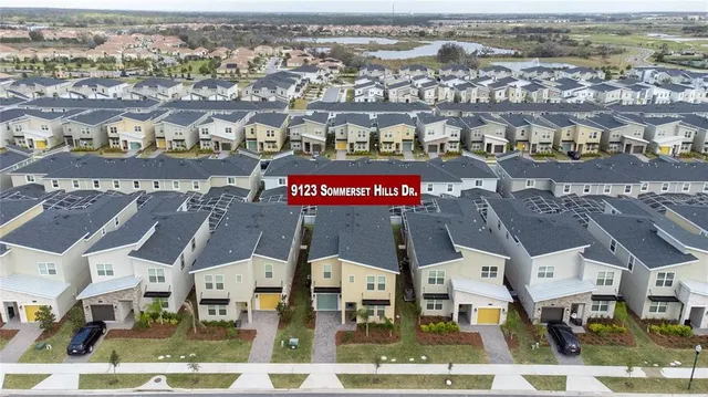 an aerial view of residential building and parking