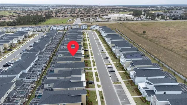 an aerial view of residential houses with outdoor space