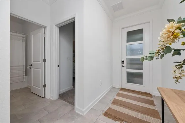 a view of an entryway with wooden floor and cabinet