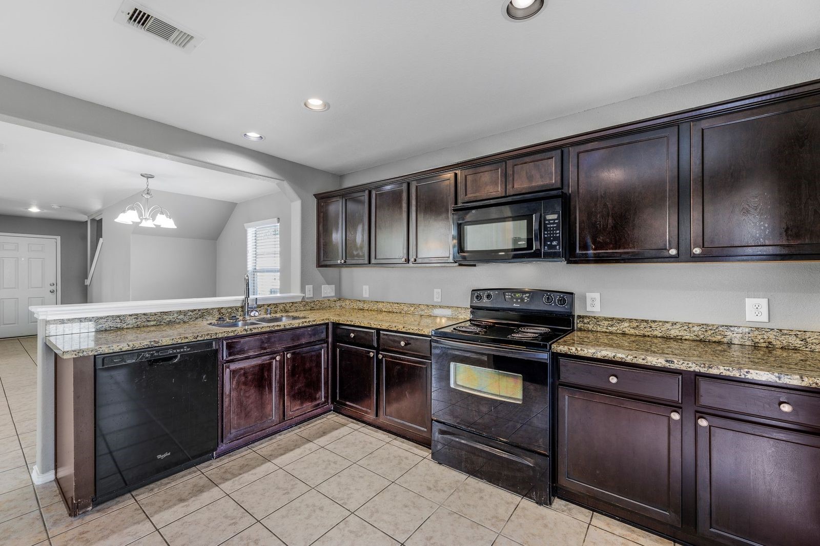 21310 Bandera Ranch Lane Katy, TX 77449 - Photo 11 of 39 a kitchen with stainless steel appliances granite countertop wooden cabinets stove top oven and sink