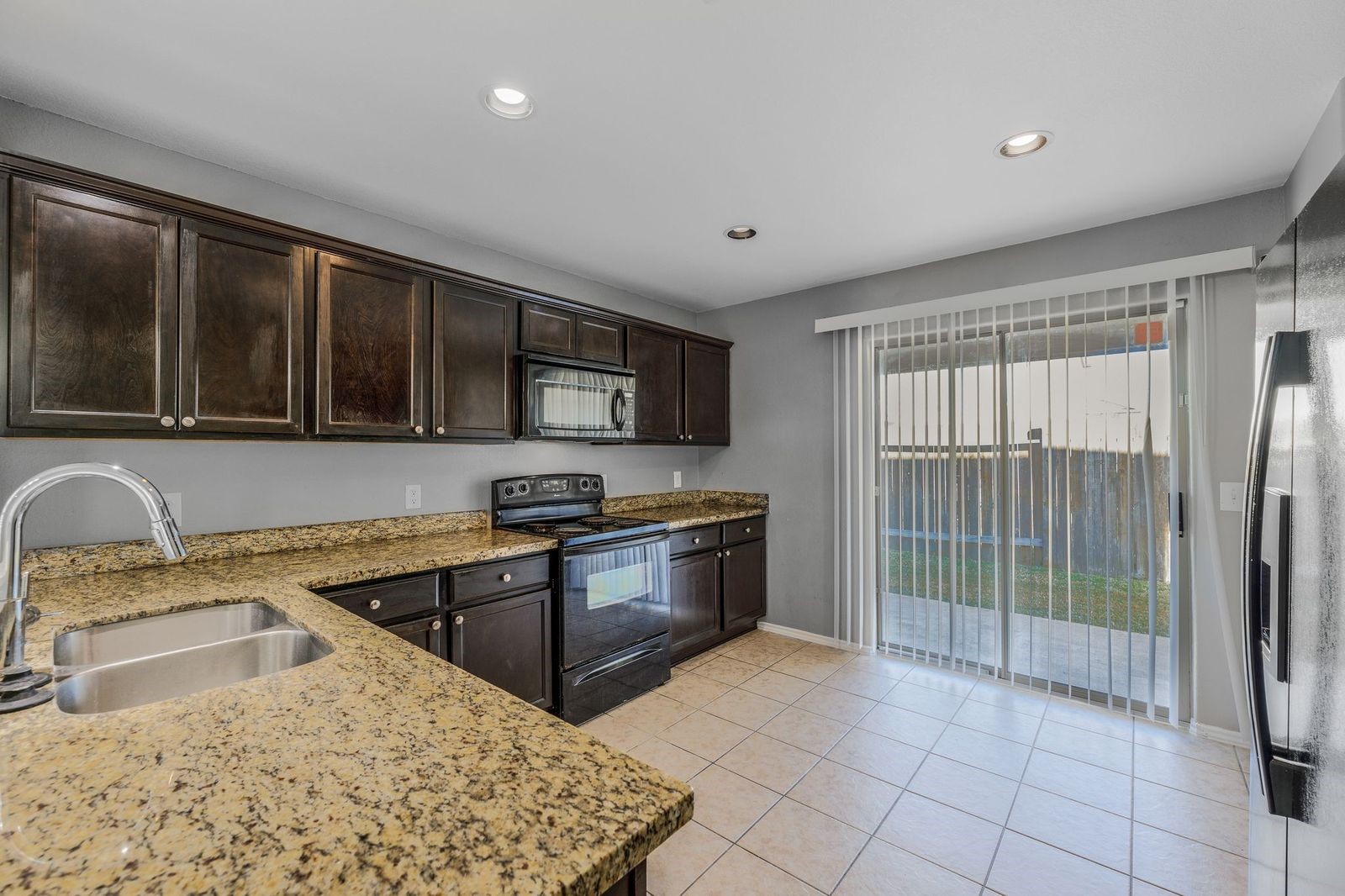 21310 Bandera Ranch Lane Katy, TX 77449 - Photo 13 of 39 a kitchen with stainless steel appliances granite countertop a sink stove and refrigerator