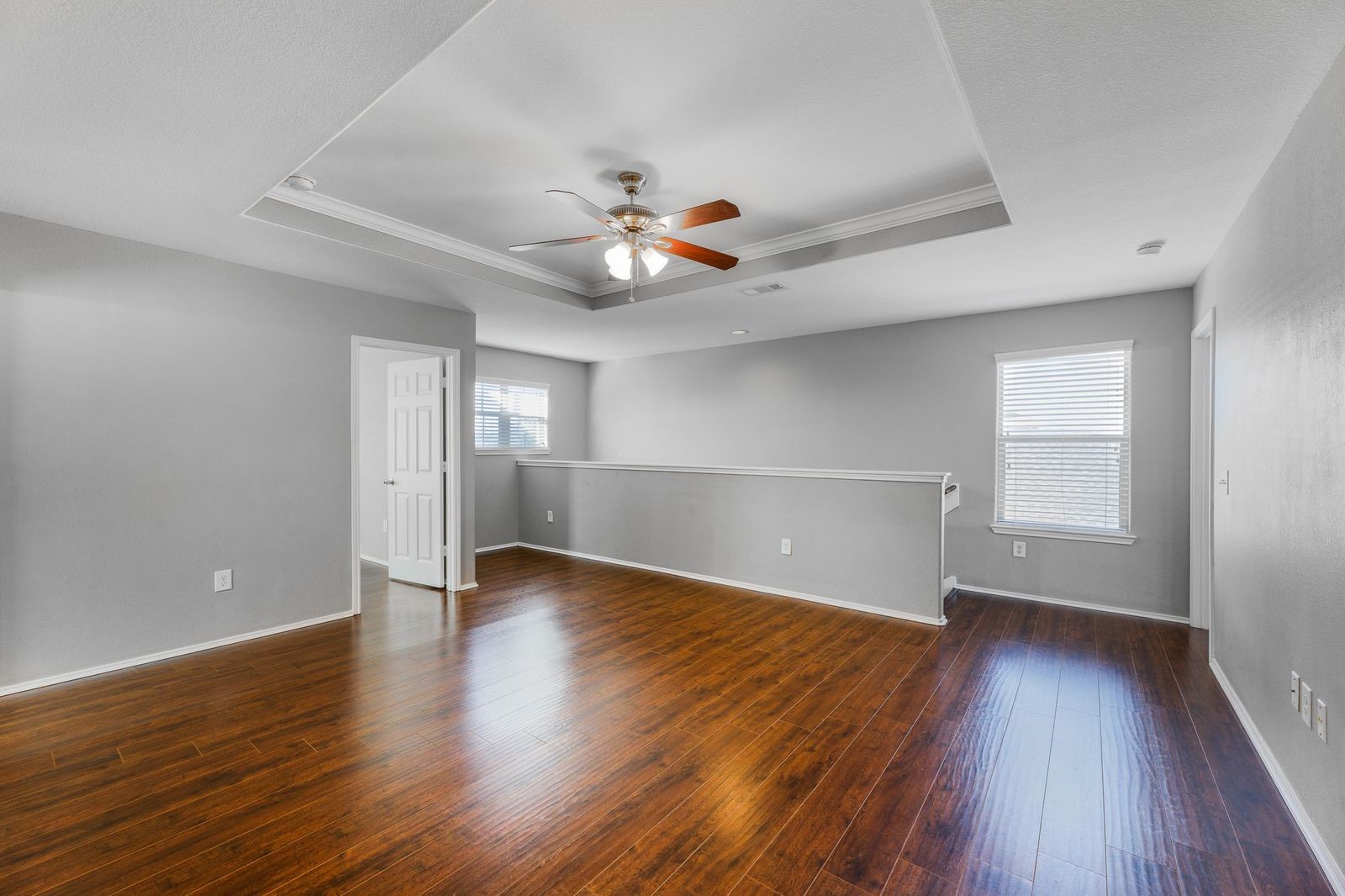 21310 Bandera Ranch Lane Katy, TX 77449 - Photo 16 of 39 an empty room with wooden floor and windows