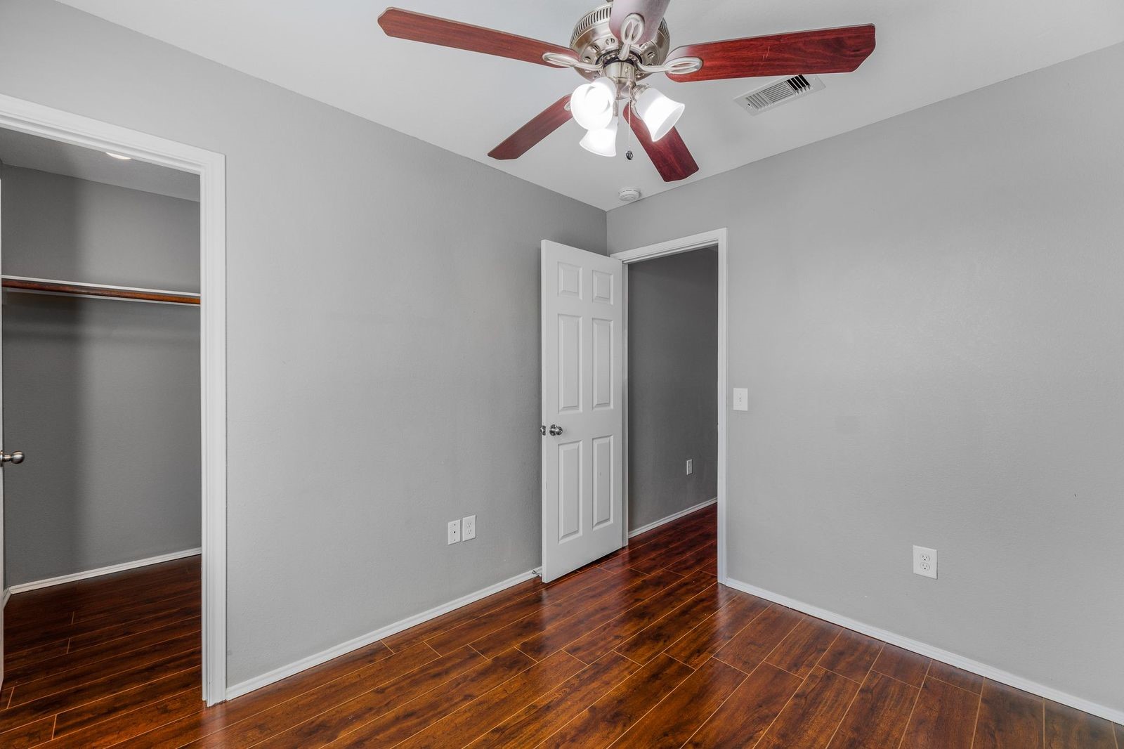 21310 Bandera Ranch Lane Katy, TX 77449 - Photo 26 of 39 an empty room with wooden floor chandelier fan and closet area