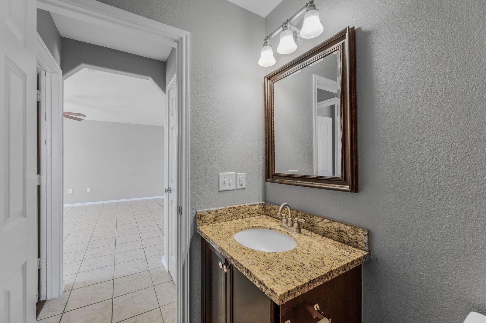 21310 Bandera Ranch Lane Katy, TX 77449 - Photo 32 of 39 a bathroom with a granite countertop sink and a mirror