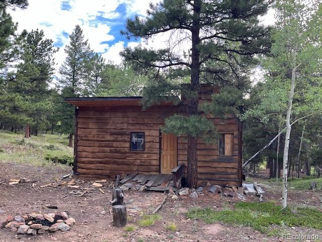 7 Tc Road Dumont, CO 80436 - Photo 5 of 9 a view of a wooden house with a yard