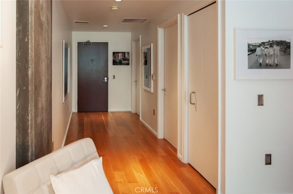 1155 South Grand Avenue, Unit 307 Los Angeles, CA 90015 - Photo 1 of 10 a view of a hallway with wooden floor and furniture