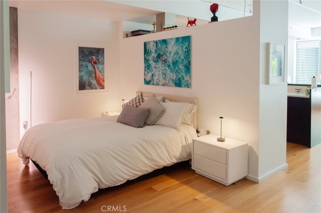 1155 South Grand Avenue, Unit 307 Los Angeles, CA 90015 - Photo 7 of 10 a bedroom with a bed and a couch