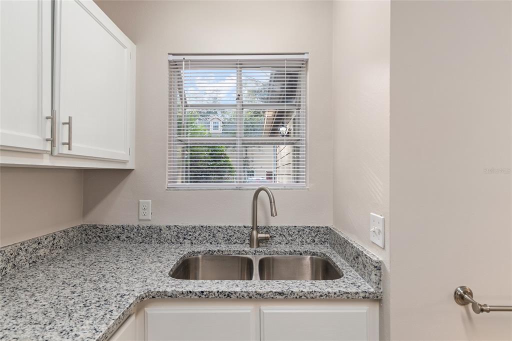 9755 Southwest 52nd Road Gainesville, FL 32608 - Photo 12 of 43 a kitchen with granite countertop a sink and a window
