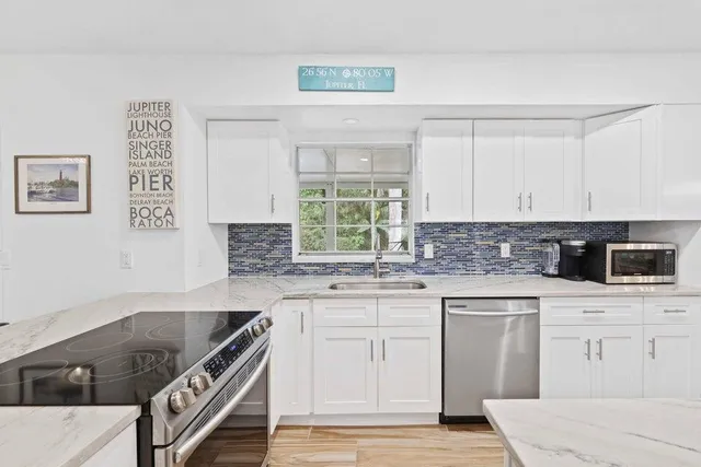 a kitchen with stainless steel appliances a dining table and chairs