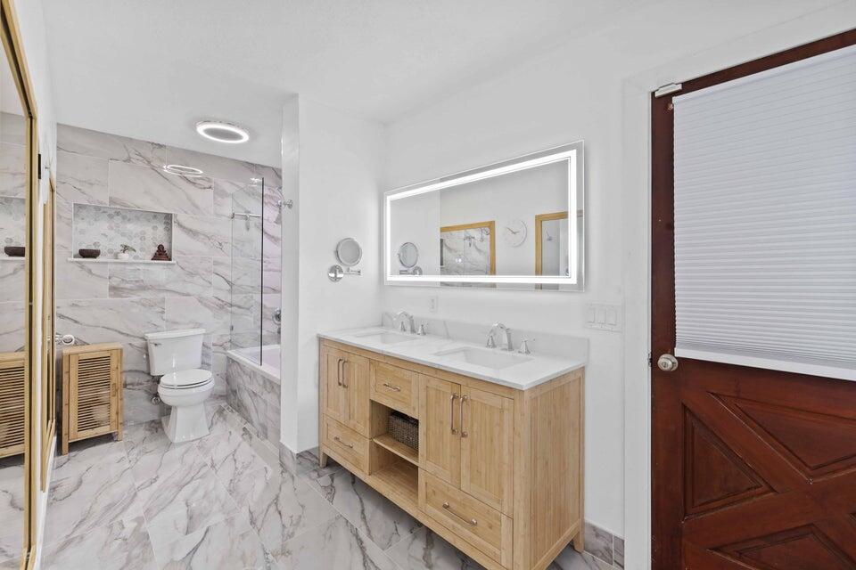 5554 Hibiscus Road Jupiter, FL 33458 - Photo 24 of 70 a spacious bathroom with a sink a toilet and shower