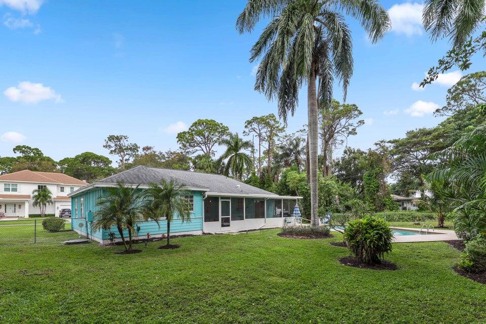 5554 Hibiscus Road Jupiter, FL 33458 - Photo 39 of 70 a view of a house with a garden
