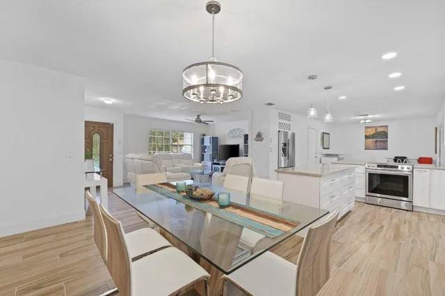 a large kitchen with stainless steel appliances granite countertop a lot of counter space and wooden floors