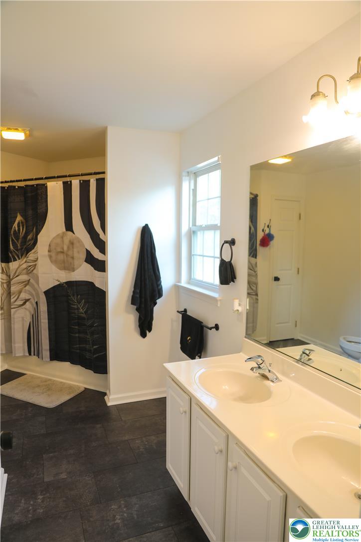 1412 Stanford Road Bethlehem, PA 18018 - Photo 43 of 58 Functional bathroom featuring a double vanity, ample mirror space, and an integrated shower.