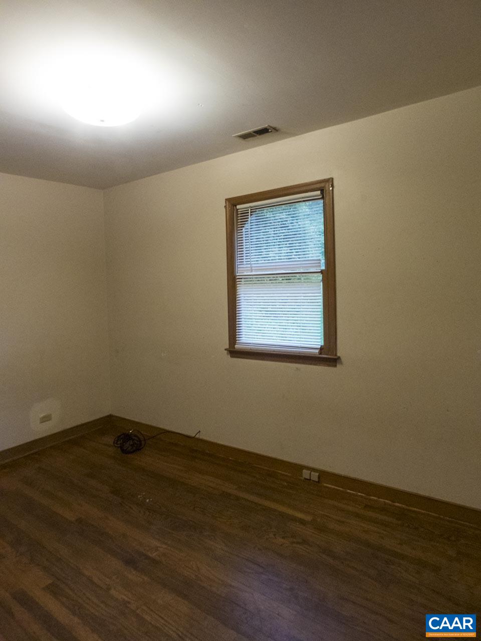 309 Valley Rd Extension Charlottesville, VA 22903 - Photo 11 of 23 an empty room with wooden floor and windows