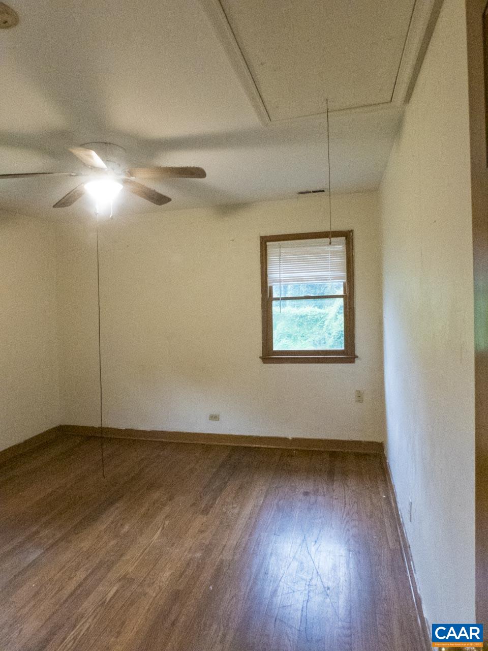 309 Valley Rd Extension Charlottesville, VA 22903 - Photo 14 of 23 an empty room with wooden floor fan and windows