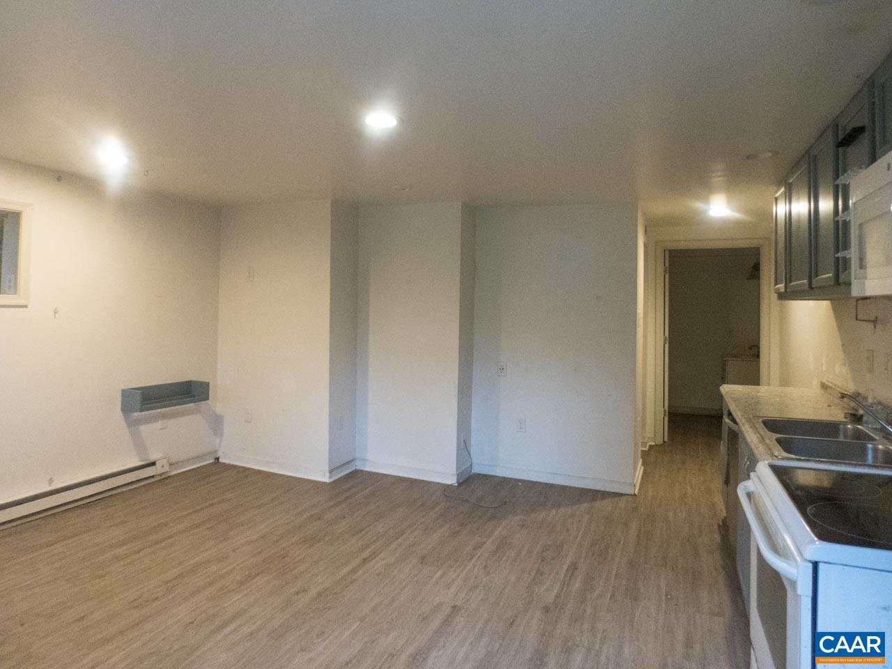 309 Valley Rd Extension Charlottesville, VA 22903 - Photo 19 of 23 a view of kitchen and empty room with wooden floor