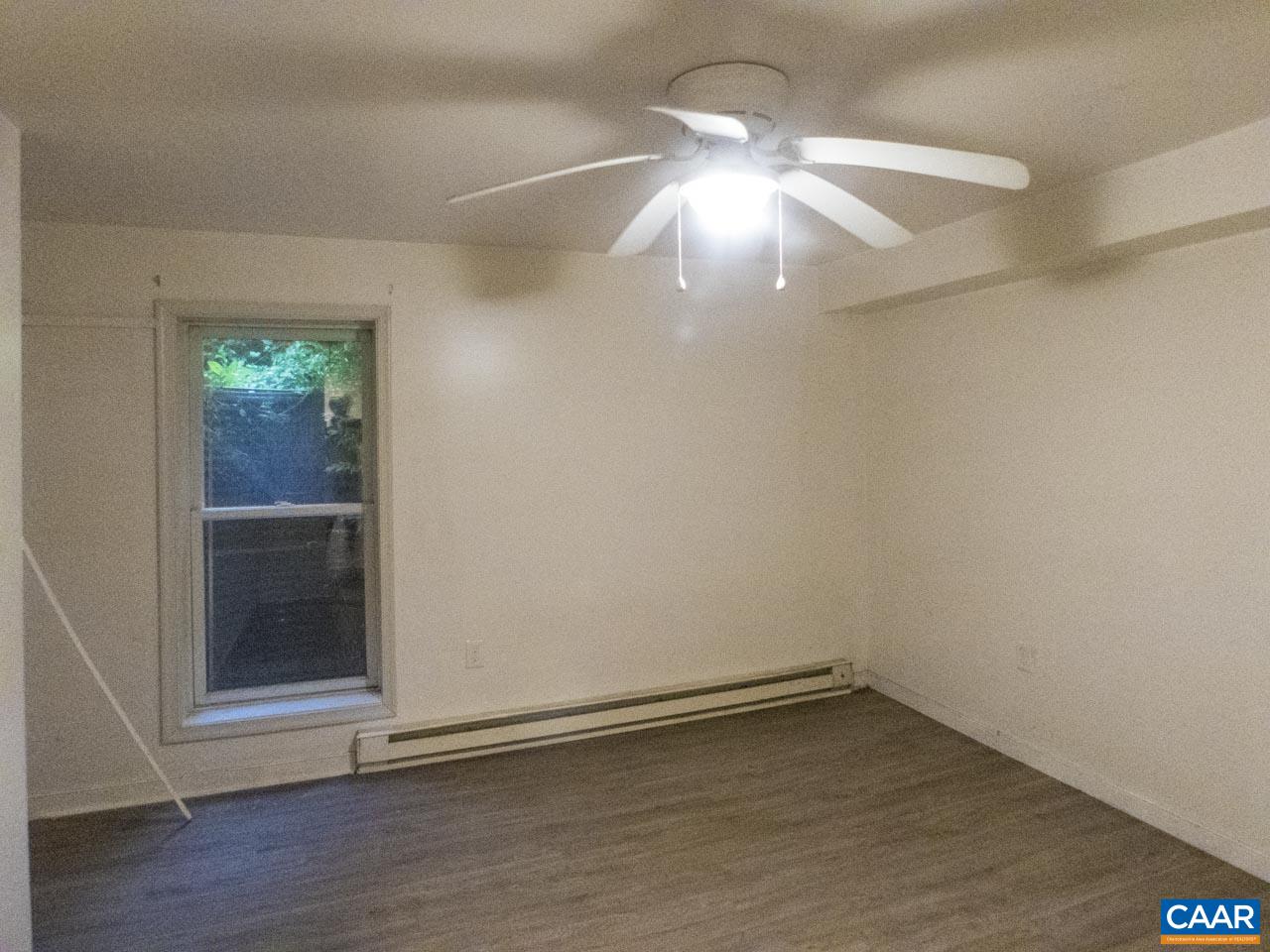309 Valley Rd Extension Charlottesville, VA 22903 - Photo 20 of 23 an empty room with wooden floor and windows