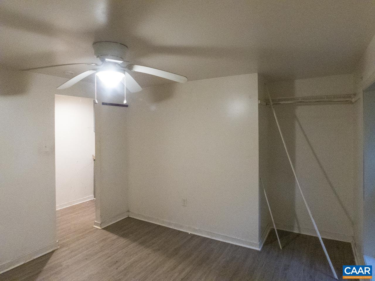 309 Valley Rd Extension Charlottesville, VA 22903 - Photo 21 of 23 an empty room with wooden floor and chandelier fan
