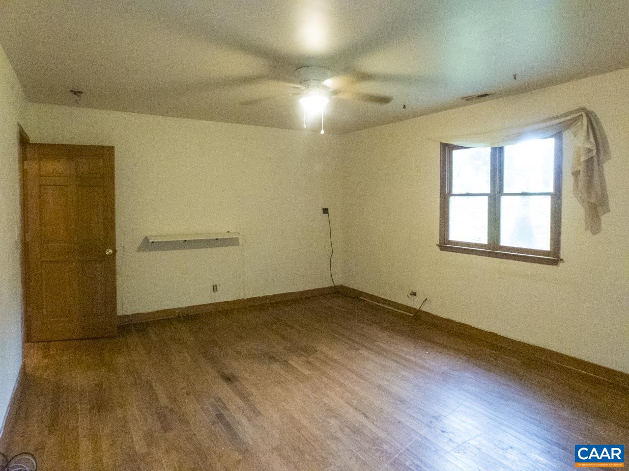 309 Valley Rd Extension Charlottesville, VA 22903 - Photo 6 of 23 an empty room with wooden floor and windows