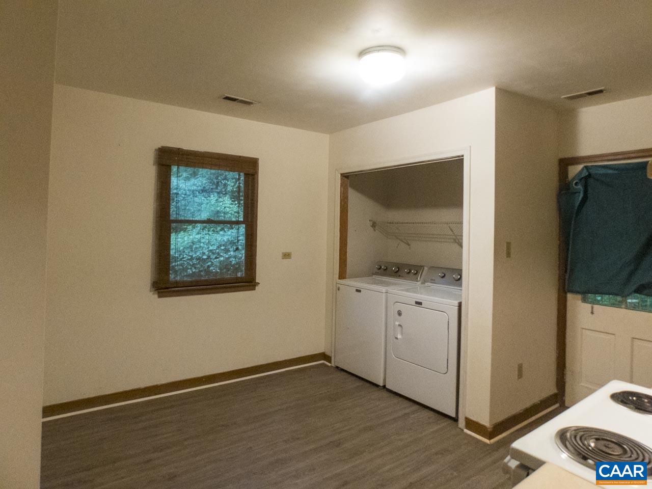 309 Valley Rd Extension Charlottesville, VA 22903 - Photo 7 of 23 a view of an empty room with wooden floor and a window