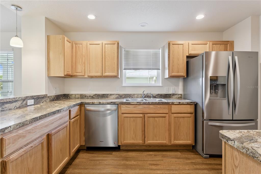 112 Turtle Run Umatilla, FL 32784 - Photo 11 of 32 a kitchen with stainless steel appliances granite countertop a sink stove and refrigerator