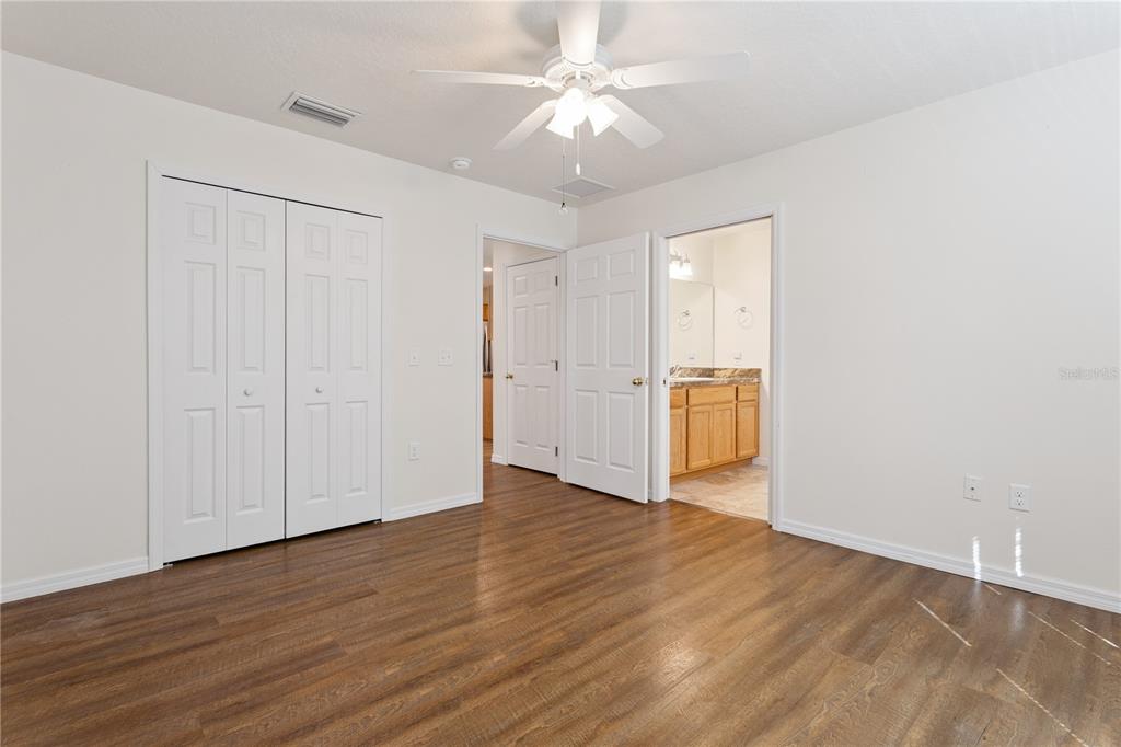 112 Turtle Run Umatilla, FL 32784 - Photo 19 of 32 an empty room with wooden floor and entryway