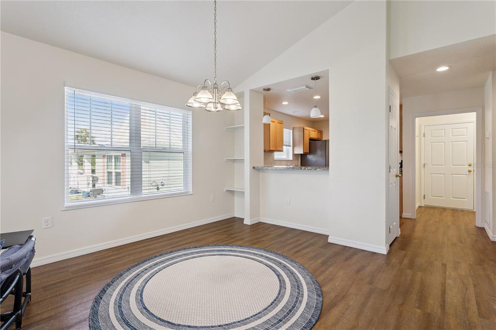 112 Turtle Run Umatilla, FL 32784 - Photo 9 of 32 a view of livingroom with chandelier and wooden floor