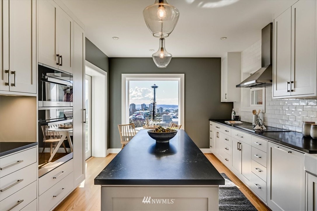357 Highland Drive Seattle, WA 98109 - Photo 11 of 38 a kitchen with stainless steel appliances a stove refrigerator and cabinets